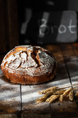 Homemade sourdough brown bread,freshly baked,whole wheat loaf. German word brot on background