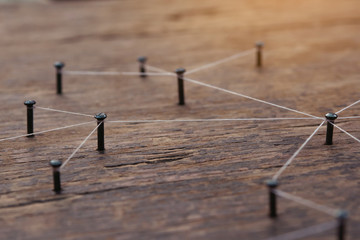 Connecting networks concept - network connected with yarn white on Plank wood with copy space....