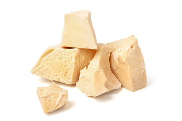 White chocolate large broken pieces on a white background