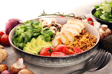 Healthy salad bowl with quinoa, tomatoes, chicken, avocado and mixed greens, lettuce. Food and health bowl