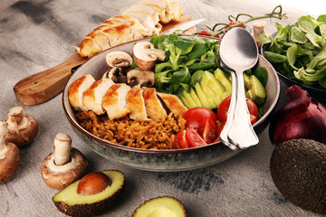Healthy salad bowl with quinoa, tomatoes, chicken, avocado and mixed greens, lettuce. Food and health bowl
