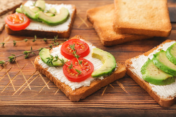 Tasty avocado sandwiches on board