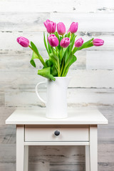 Bouquet of pink tulips on a white table