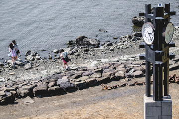 Girls at beach of Odaiba and tower clock ahead, Tokyo