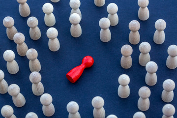 Personal development. Wooden figure in a crowd. Think different.