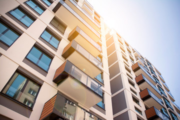 Apartment residential house and home facade architecture and outdoor facilities. Blue sky on the background. Sunlight