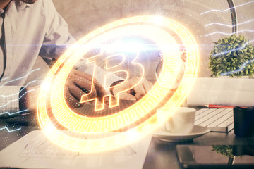 Double exposure of man's hands holding and using a phone and crypto currency blockchain theme drawing.