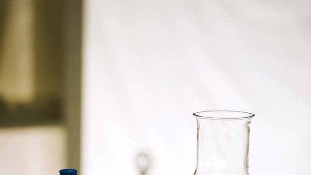 The empty glass beaker on top of the table