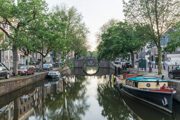 Fototapeta na wymiar Amsterdam canal with boats and a bridge