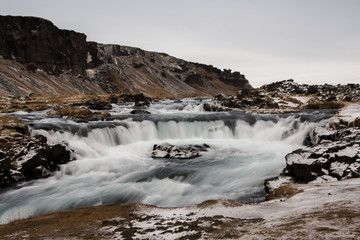 Fototapeta premium River stream in Iceland nature in wintertime during a cloudy day. Explore barely populated Viking`s land. Iceland, Europe.