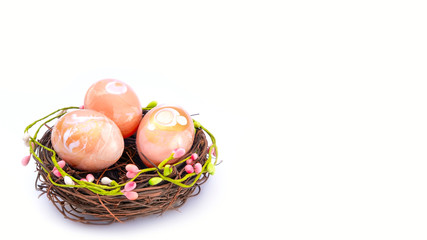 Wicker nest, basket with pink golden decorated eggs isolated on white background. Ester banner greeting card, promotion flyer. Copy space, front view, vibrant colours