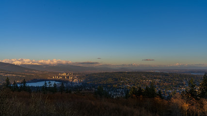 Fototapeta na wymiar city panorama with snow-capped mountain skyline