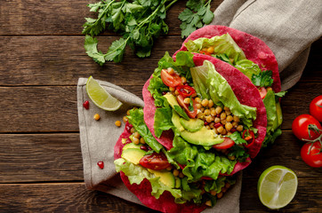Vegan beetroot taco with salad, avocado, chickpea and vegetables