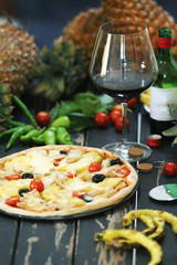 Pineapple pizza served with wine