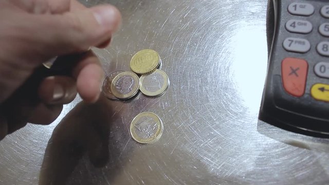 The buyer in the store pays for the purchase at the cash register.