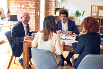 Group of business workers smiling happy and confident. Speaking with smile on face working together at the office.