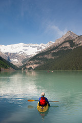Man with gery hair canoing in Lake Louise, Banff