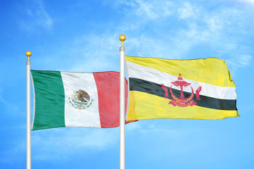 Mexico and Brunei two flags on flagpoles and blue cloudy sky