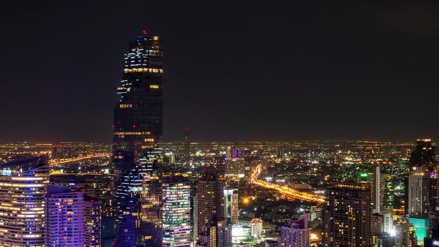 Bangkok business district city center above Sathon area, with buildings and skyscrapers, rush hour traffic, at night – Time Lapse