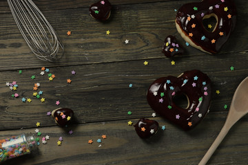 donuts with chocolate glaze on a black wooden table, home made donuts, donuts and chocolate chips