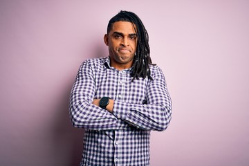 Fototapeta premium Young handsome african american afro man with dreadlocks wearing casual shirt skeptic and nervous, disapproving expression on face with crossed arms. Negative person.