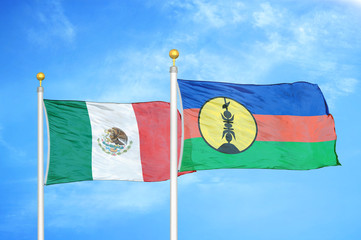 Mexico and New Caledonia two flags on flagpoles and blue cloudy sky