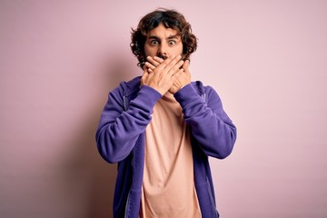 Young handsome sporty man with beard wearing casual sweatshirt over pink background shocked covering mouth with hands for mistake. Secret concept.