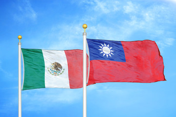 Mexico and Taiwan two flags on flagpoles and blue cloudy sky