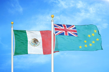 Mexico and Tuvalu two flags on flagpoles and blue cloudy sky