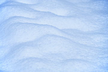 Snow texture. Natural winter background with snow waves