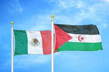 Mexico and Western Sahara two flags on flagpoles and blue cloudy sky