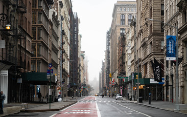 Empty New York City streets without people and closed shops during pandemic coronavirus outbreak in...