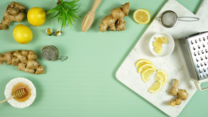 Fototapeta na wymiar Ginger and lemon herbal tea preparation flat lay, with its high levels of Vitamin C, magnesium and other minerals, ginger root is extremely beneficial for health and boosting the immune system.