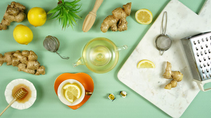 Ginger and lemon herbal tea preparation flat lay, with its high levels of Vitamin C, magnesium and...