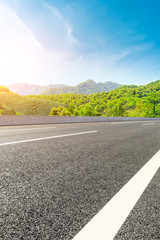 Empty asphalt road and green tea plantation nature landscape. © ABCDstock