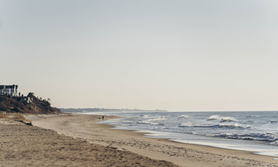 Atlantic Ocean beach with strong waves. Long Island New York shore. Blue sky with blue ocean. 