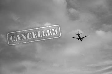 Cancelled stamp with plane flying, concept of cancelled flights.