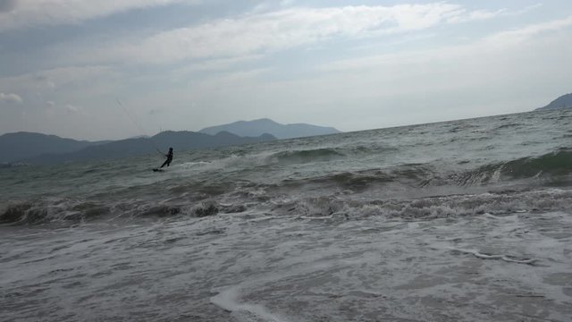 Fethiye, Turkey - 27th of Martch 2020: 4K Kitesurfer makes a somersault and rides away
