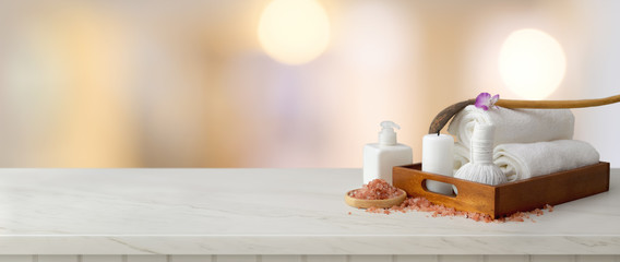 Cropped shot of spa accessories with white towel and candle in wooden tray with spa salt, aroma oil