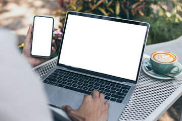 mockup image blank screen computer,cell phone with white background for advertising text,hand woman using laptop texting mobile contact business search information on desk in cafe.marketing,design