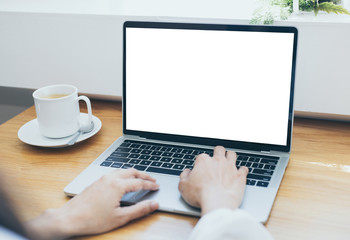 Fototapeta premium mockup image blank screen computer with white background for advertising text,hand woman using laptop contact business search information on desk at coffee shop.marketing and creative design