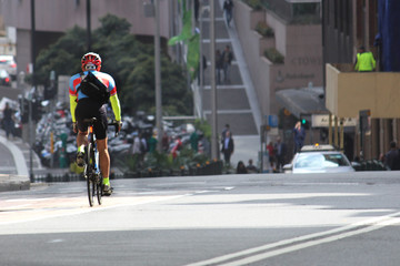 Athletic cyclist riding down hill on Druitt Street, Sydney