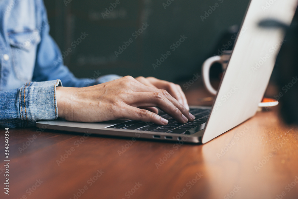 Wall mural using computer.hand typing message on keyboard laptop online chatting search information form intern