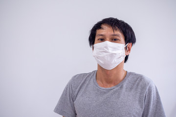 Face image of Asian men wearing masks to protect against Corona Virus or Covid 19 and toxic fumes and dust. PM 2.5