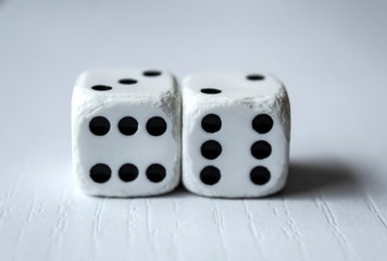 Macro photograhpy to an Old white dices with double six pair over a white table