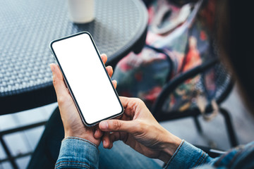 cell phone Mockup image blank white screen.woman hand holding texting using mobile on desk at coffee shop.background empty space for advertise text.people contact marketing business,technology