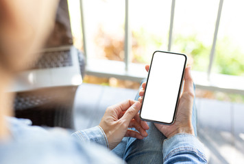 cell phone Mockup image blank white screen.woman hand holding texting using mobile on desk at coffee shop.background empty space for advertise text.people contact marketing business,technology