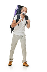 Fototapeta premium young man with backpack walking in protective mask on white background