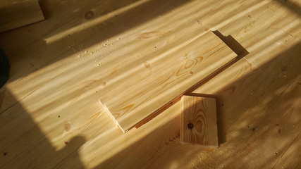 Sanding a wooden floor on a sunny day.