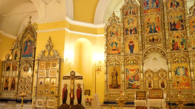 Beautiful Golden interior of Church with bright icons. Stock footage. Beautiful iconostasis in middle of Golden hall of Church. Luxury gold interior of Church